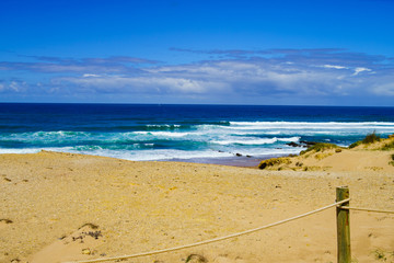 sand beach and blue sky. Soft wave of blue ocean on sandy beach.