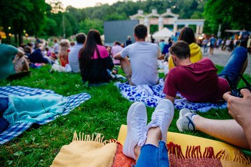 people watching movie in open air cinema in city park - obrazy, fototapety, plakaty