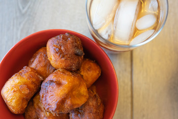 Nigerian Puff Puff in Red bowl with cold Refreshing Iced Tea