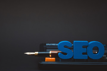SEO text alphabet for Search Engine Optimization concept and Office supplies or office work essential tools or item calculator, business SEO idea.