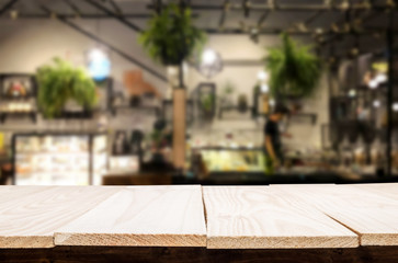 Selected focus empty brown wooden table and Coffee shop or restaurant blur background with bokeh image. for your photomontage or product display