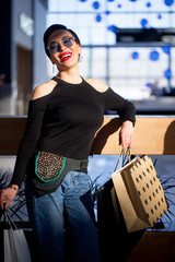 Young woman with shopping bags walking in mall