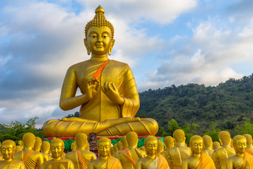 the golden big Buddha statue among a lot of small Buddha statues in Makha Bucha Buddhist memorial park at Nakornnayok province.
