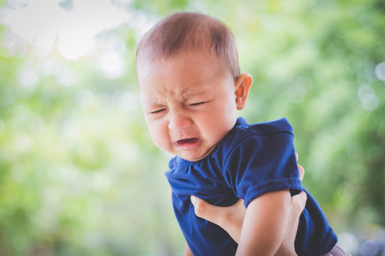 Portrait of cute newborn baby crying, Sad Asian child