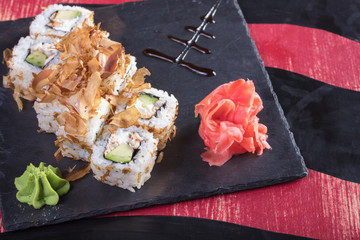 Суши и роллы и креветки. Японская еда и морепродукты в ресторане. Японская кухня. Горячие и холодные закуски из морепродуктов
