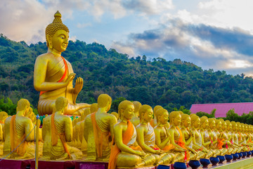 the golden big Buddha statue among a lot of small Buddha statues in Makha Bucha Buddhist memorial park at Nakornnayok province.