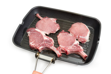 Pork loin chops bone on the grill pan during cooking