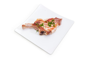 Grilled pork loin chop on white square dish