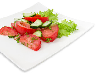 Vegetable salad with tomatoes and cucumbers closeup at selective focus