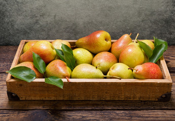 fresh pears with leaves in a box