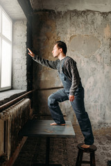 Man pulls his hand to window with light