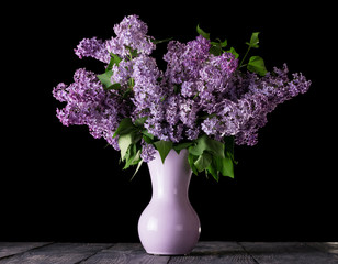 Lush bouquet of blooming lilac in vase isolated on black