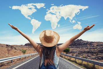 Happy travel woman on vacation concept with world shaped clouds. Funny traveler enjoy her trip and ready to adventure.