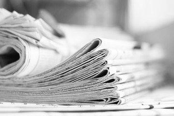 Pile of newspapers. Daily papers with news folded and rolled. Headlines and articles partially shown on pages of tabloid journals, concept for business press    