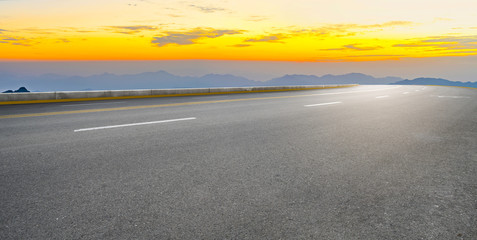 Asphalt road square and river hill under the blue sky