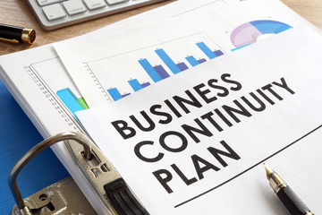 Business continuity plan in a blue folder. - obrazy, fototapety, plakaty