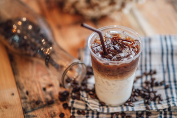 caramel macchiato ice In plastic glass, coffee ice on wood