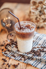 caramel macchiato ice In plastic glass, coffee ice on wood