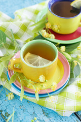 Cups of herbal tea with linden blossoms and lemon