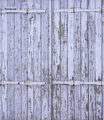 background consisting of peeling blue purple paint on old door