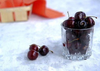 Ripe juicy sweet cherries in a glass. Copy space, summer concept.