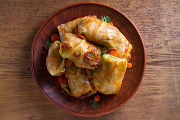 Cabbage rolls with meat, rice and vegetables. Stuffed cabbage leaves with meat. Chou farci, dolma, sarma, golubtsy or golabki. View from above, top studio shot