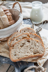 A beautiful loaf of sourdough bread from white wheat on a plate on a linen edge. Homemade pastries