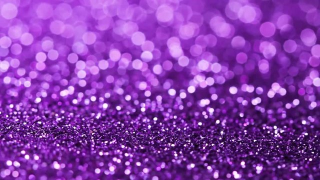 Purple glitter texture rotating. Shiny abstract background.
