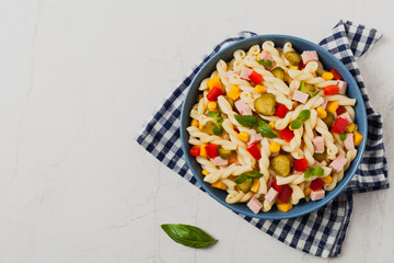 Italian fusilli pasta in a salad with ham and vegetables.