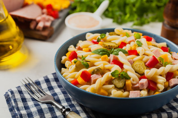 Italian fusilli pasta in a salad with ham and vegetables.