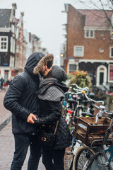Fototapeta na wymiar guy and girl in the street in the rain
