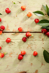 Naklejka na ściany i meble Cherries on a rustic green table