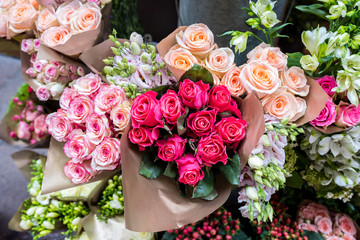 Beautiful bouquets of roses are presented in street flower shop, Italy.