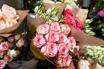 Beautiful bouquets of roses are presented in street flower shop, Italy.