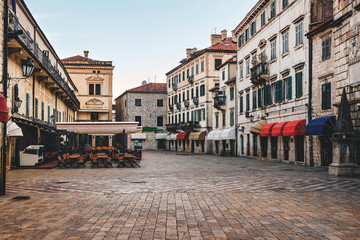 Square with old historical buildings in the ancient town Kotor in Montenegro - obrazy, fototapety, plakaty