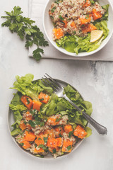 Healthy quinoa salad with roasted pumpkin and greens, top view. Healthy vegan food concept.