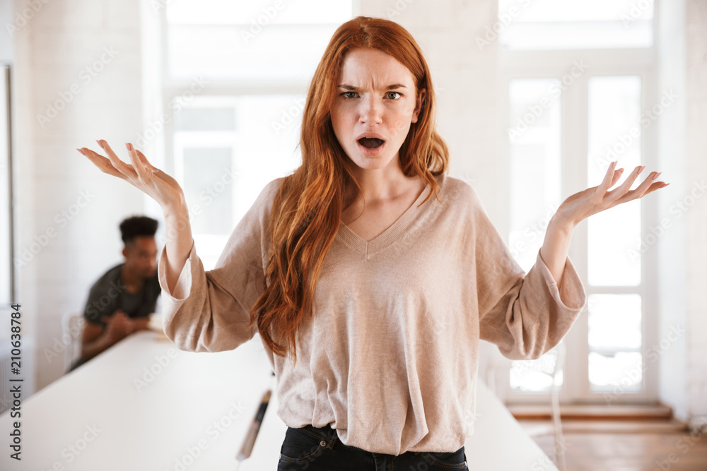 Sticker Confused displeased young redhead lady