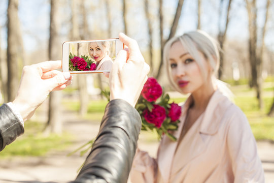 Making Photo with Smartphone. Fashion photo of young woman on display