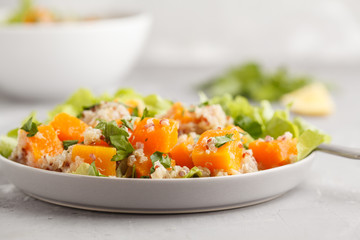 Healthy quinoa salad with roasted pumpkin and greens, macro. Superfood and clean eating concept.