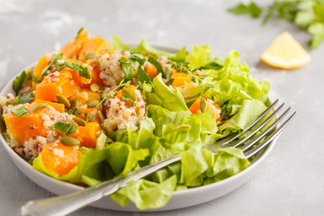 Healthy quinoa salad with roasted pumpkin and greens. Superfood and clean eating concept.