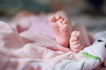 Small legs of newborn baby.