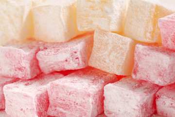 Extreme close up of traditional bulgarian rose flavoured and ordinary turkish delight cubes with powdered sugar icing