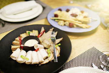 Served dishes to the table for holiday. Cutlery and food on whit