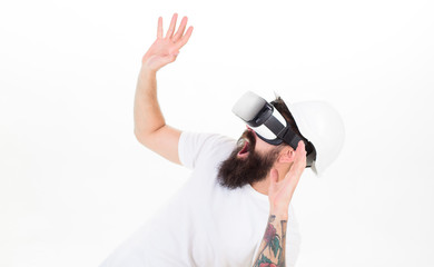 Man with beard in VR glasses and helmet, white background. Virtual reality concept. Hipster on shouting scared face use modern technology. Guy with head mounted display interact in virtual reality