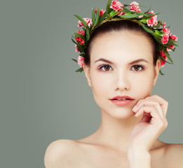 Fototapeta na wymiar Perfect Girl with Healthy Skin and Flowers on Grey Background with Copy space