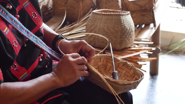 Hand working on bamboo weaving in Thailand.