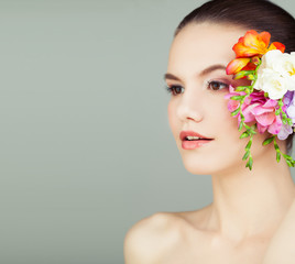 Fototapeta na wymiar Spa Woman with Healthy Skin and Flowers on Grey Background, Spa Beauty