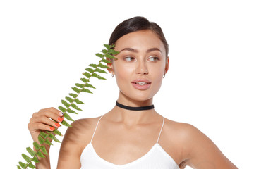 model with natural make up and green leaf isolated on white. Spa and wellness.