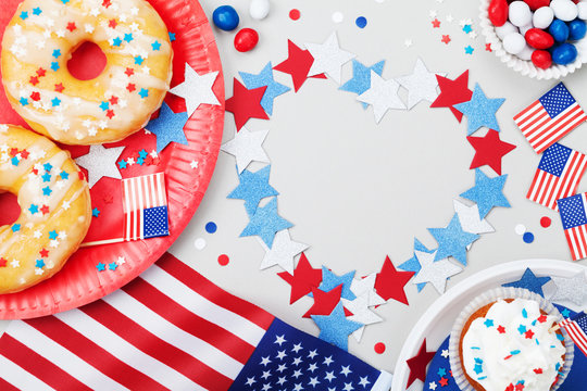Happy Independence Day 4th july background with american flag decorated of sweet foods, stars and confetti. Holidays table top view.