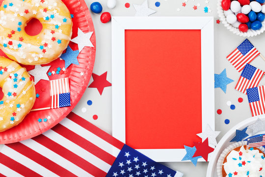 Happy Independence Day 4th july mockup with american flag and sweet foods, decorated with candy, stars and confetti. Top view.